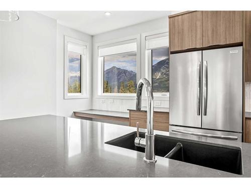 201F-209 Stewart Creek Rise, Canmore, AB - Indoor Photo Showing Kitchen With Double Sink