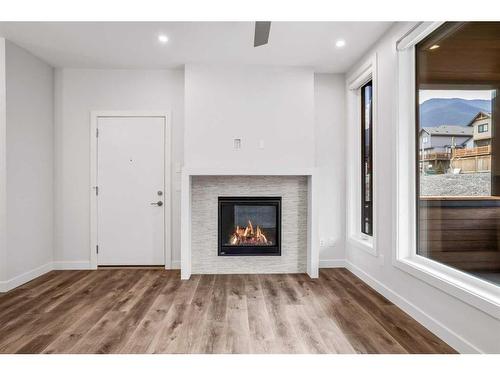 201F-209 Stewart Creek Rise, Canmore, AB - Indoor Photo Showing Living Room With Fireplace