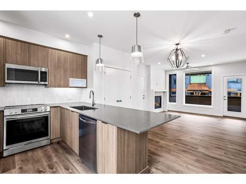 201F-209 Stewart Creek Rise, Canmore, AB - Indoor Photo Showing Kitchen With Upgraded Kitchen