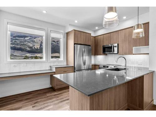 201F-209 Stewart Creek Rise, Canmore, AB - Indoor Photo Showing Kitchen With Upgraded Kitchen