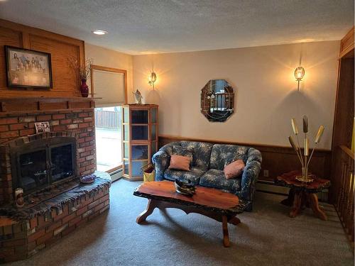 718 6 Avenue, Fox Creek, AB - Indoor Photo Showing Living Room With Fireplace