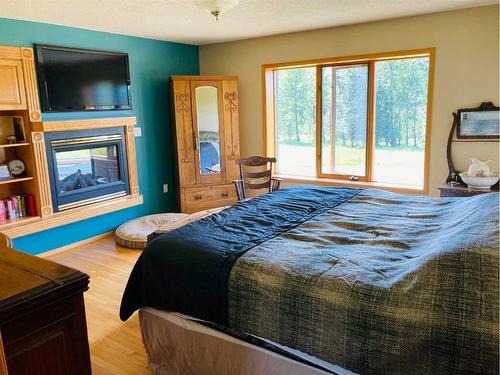 590032 Range Road 111A, Rural Woodlands County, AB - Indoor Photo Showing Bedroom With Fireplace