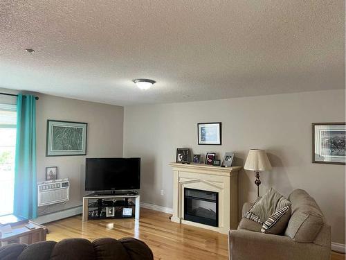 207-5037 7 Avenue, Edson, AB - Indoor Photo Showing Living Room With Fireplace