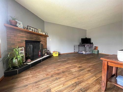 107 Assiniboine Drive, Swan Hills, AB - Indoor Photo Showing Living Room With Fireplace