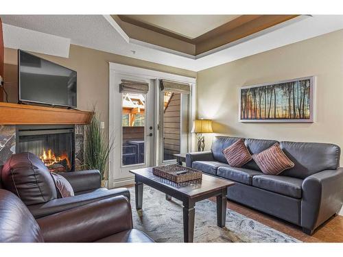 305-191 Kananaskis Way, Canmore, AB - Indoor Photo Showing Living Room With Fireplace