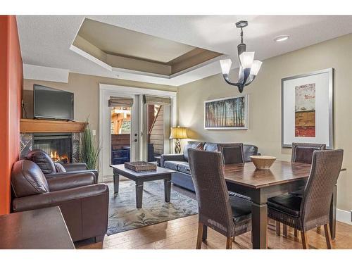 305-191 Kananaskis Way, Canmore, AB - Indoor Photo Showing Dining Room With Fireplace