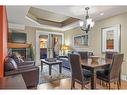 305-191 Kananaskis Way, Canmore, AB  - Indoor Photo Showing Dining Room With Fireplace 