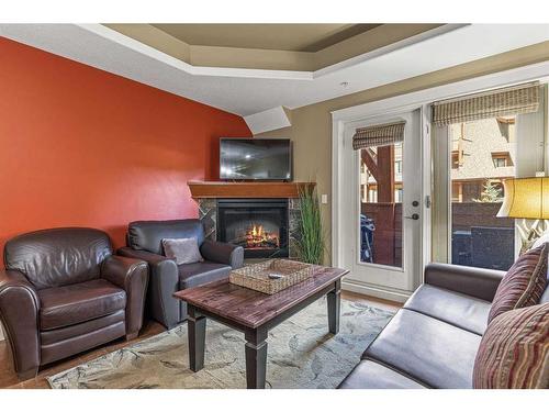 305-191 Kananaskis Way, Canmore, AB - Indoor Photo Showing Living Room With Fireplace