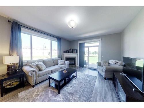 104-605 6 Avenue Se, Slave Lake, AB - Indoor Photo Showing Living Room With Fireplace