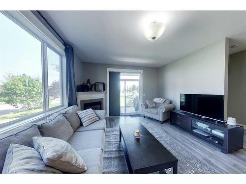 104-605 6 Avenue Se, Slave Lake, AB - Indoor Photo Showing Living Room With Fireplace