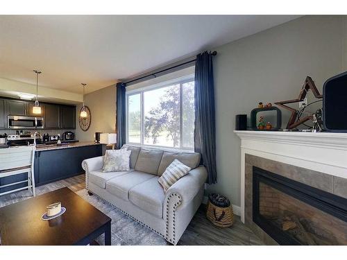 104-605 6 Avenue Se, Slave Lake, AB - Indoor Photo Showing Living Room With Fireplace