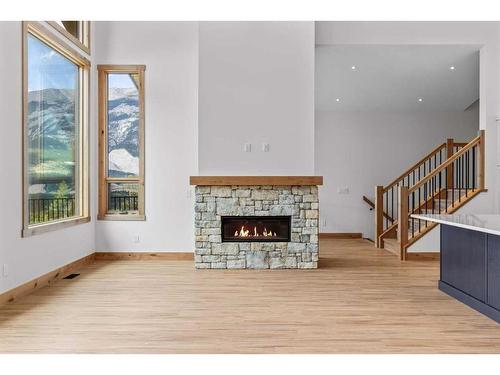 236 Stewart Creek Rise, Canmore, AB - Indoor Photo Showing Living Room With Fireplace