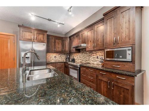 316-106 Stewart Creek Landing, Canmore, AB - Indoor Photo Showing Kitchen With Double Sink