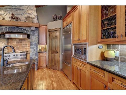 220 Miskow Close, Canmore, AB - Indoor Photo Showing Kitchen With Fireplace With Double Sink