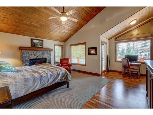 220 Miskow Close, Canmore, AB - Indoor Photo Showing Bedroom With Fireplace