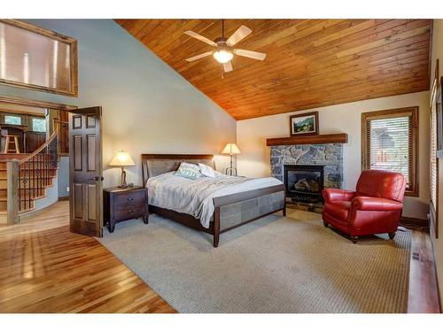 220 Miskow Close, Canmore, AB - Indoor Photo Showing Bedroom With Fireplace