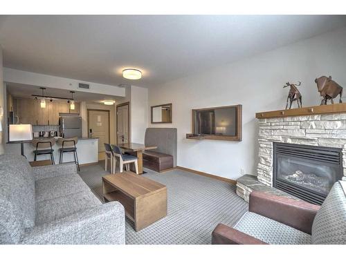 213-190 Kananaskis Way, Canmore, AB - Indoor Photo Showing Living Room With Fireplace