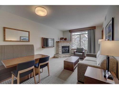 213-190 Kananaskis Way, Canmore, AB - Indoor Photo Showing Living Room With Fireplace