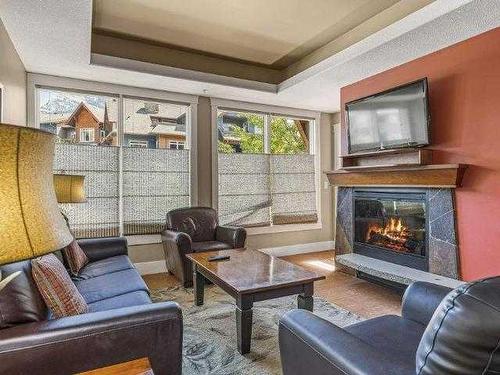 224-173 Kananaskis Way, Canmore, AB - Indoor Photo Showing Living Room With Fireplace