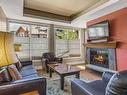 224-173 Kananaskis Way, Canmore, AB  - Indoor Photo Showing Living Room With Fireplace 