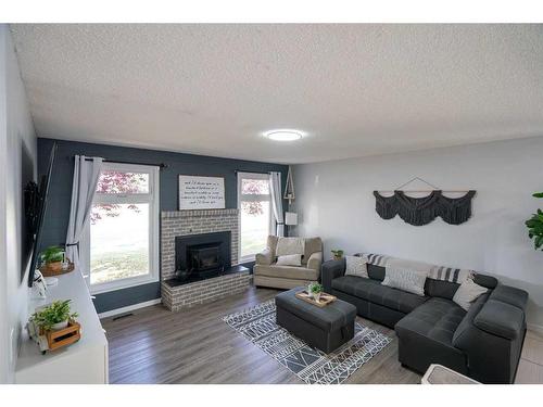 77 Feero Drive, Whitecourt, AB - Indoor Photo Showing Living Room With Fireplace