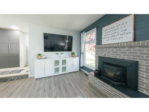 77 Feero Drive, Whitecourt, AB - Indoor Photo Showing Living Room With Fireplace