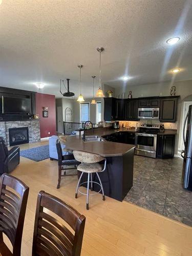 11-120053 Township Road 584, Rural Woodlands County, AB - Indoor Photo Showing Kitchen With Fireplace With Double Sink With Upgraded Kitchen