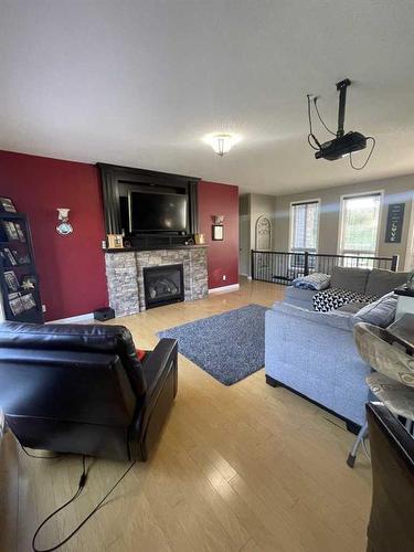 11-120053 Township Road 584, Rural Woodlands County, AB - Indoor Photo Showing Living Room With Fireplace