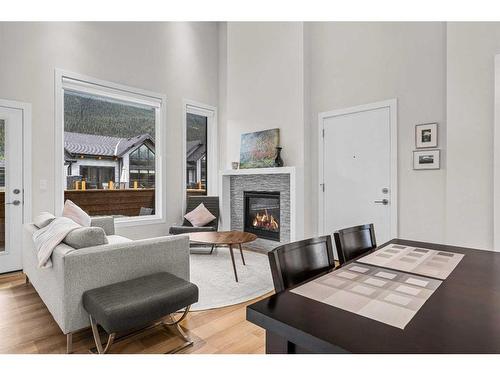 302H-209 Stewart Creek Rise, Canmore, AB - Indoor Photo Showing Living Room With Fireplace