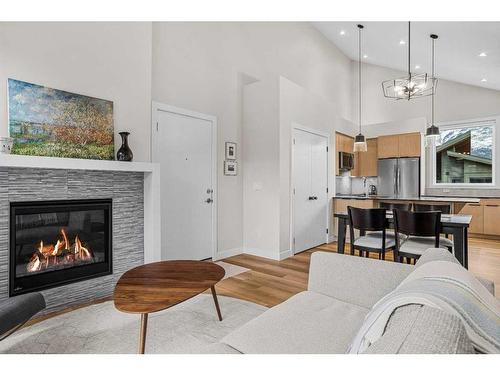 302H-209 Stewart Creek Rise, Canmore, AB - Indoor Photo Showing Living Room With Fireplace