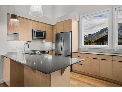 302H-209 Stewart Creek Rise, Canmore, AB - Indoor Photo Showing Kitchen With Upgraded Kitchen