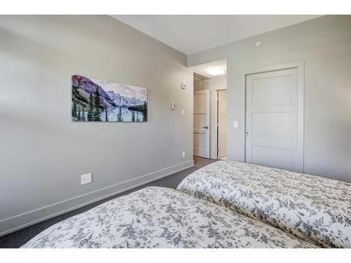 203-3000A Stewart Creek Drive, Canmore, AB - Indoor Photo Showing Bedroom