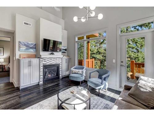 203-3000A Stewart Creek Drive, Canmore, AB - Indoor Photo Showing Living Room With Fireplace