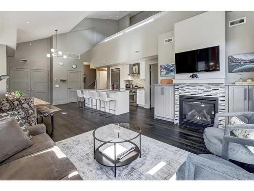 203-3000A Stewart Creek Drive, Canmore, AB - Indoor Photo Showing Living Room With Fireplace