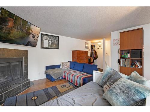 103-440 Cougar Street, Banff, AB - Indoor Photo Showing Living Room With Fireplace