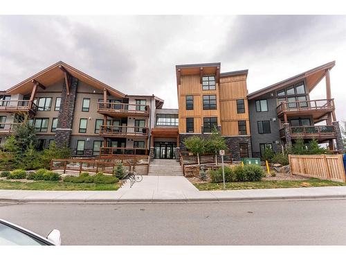 304-106 Stewart Creek Rise, Canmore, AB - Outdoor With Balcony With Facade