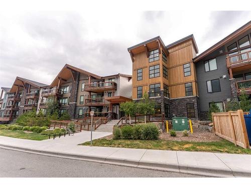 304-106 Stewart Creek Rise, Canmore, AB - Outdoor With Balcony With Facade