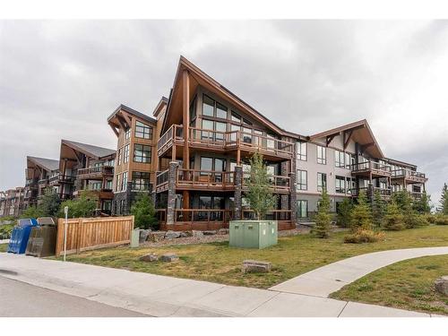 304-106 Stewart Creek Rise, Canmore, AB - Outdoor With Balcony With Facade