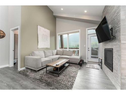 304-106 Stewart Creek Rise, Canmore, AB - Indoor Photo Showing Living Room With Fireplace