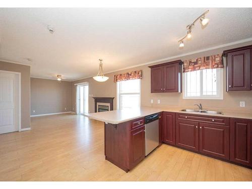 101, 202, 303, 304-2814- 48 Avenue, Athabasca, AB - Indoor Photo Showing Kitchen With Fireplace With Double Sink