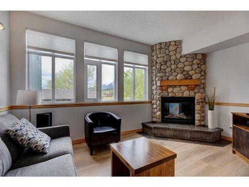 205-1151 Sidney, Canmore, AB - Indoor Photo Showing Living Room With Fireplace