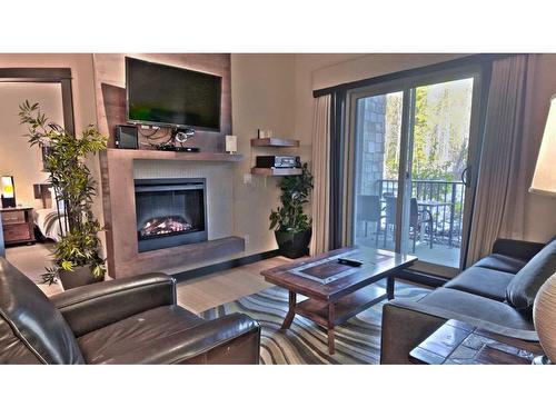 117-1818 Mountain Avenue, Canmore, AB - Indoor Photo Showing Living Room With Fireplace