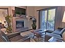 117-1818 Mountain Avenue, Canmore, AB  - Indoor Photo Showing Living Room With Fireplace 