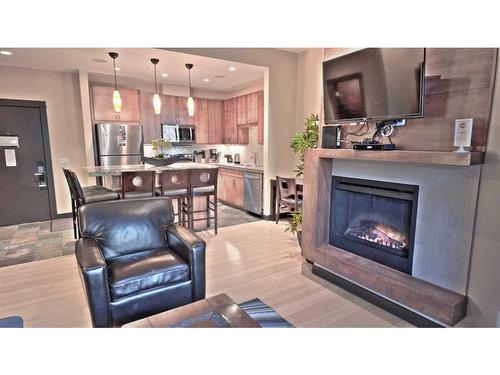 117-1818 Mountain Avenue, Canmore, AB - Indoor Photo Showing Living Room With Fireplace