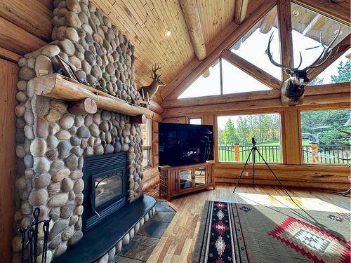 583030B Range Road 121, Rural Woodlands County, AB - Indoor Photo Showing Living Room With Fireplace