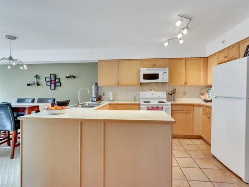 404-743 Railway Avenue, Canmore, AB - Indoor Photo Showing Kitchen With Double Sink