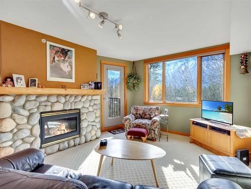 404-743 Railway Avenue, Canmore, AB - Indoor Photo Showing Living Room With Fireplace