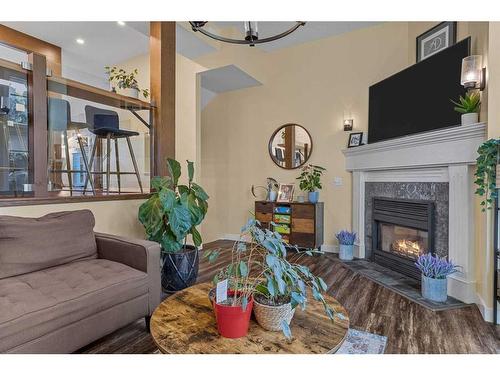 516-1080B Cougar Creek Drive Se, Canmore, AB - Indoor Photo Showing Living Room With Fireplace