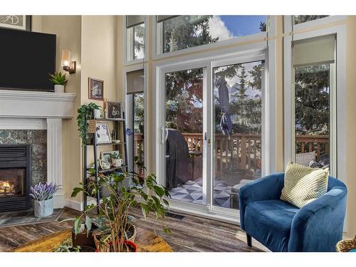 516-1080B Cougar Creek Drive Se, Canmore, AB - Indoor Photo Showing Living Room With Fireplace