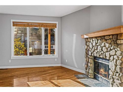 400-200 Rabbit Street, Banff, AB - Indoor Photo Showing Living Room With Fireplace